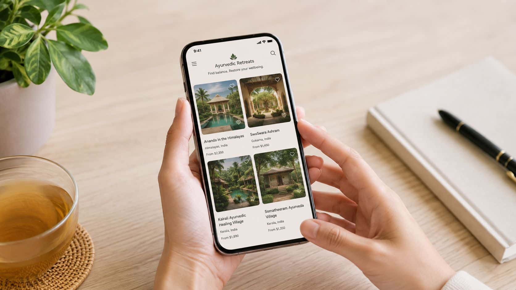 A person holding a smartphone showing an app interface for booking Ayurvedic health retreats worldwide.
